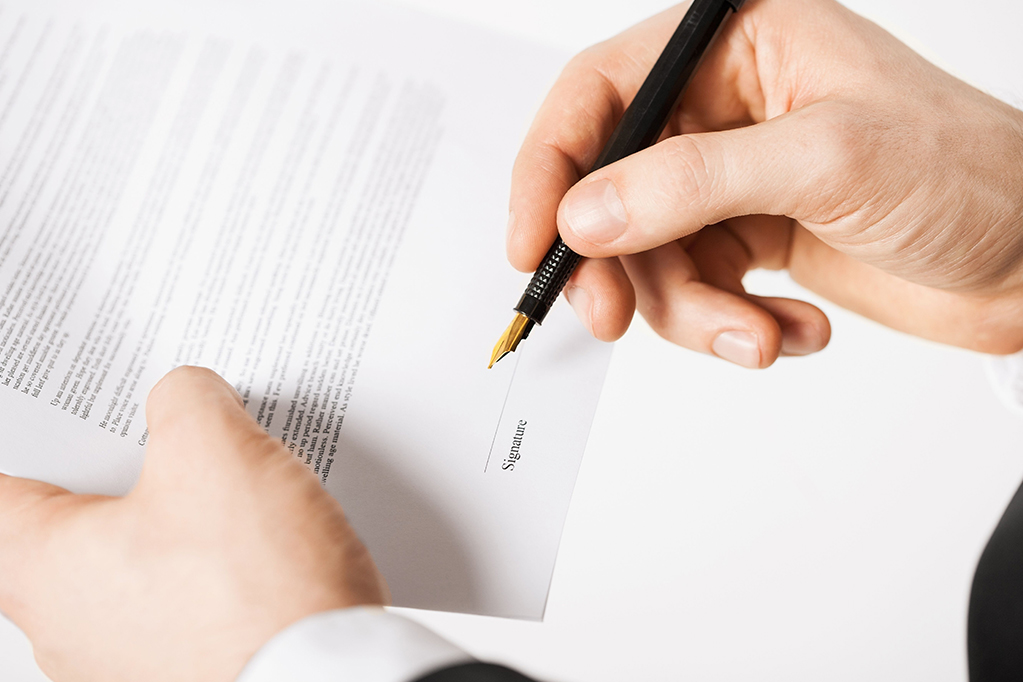 Picture of man hands signing contract with random text