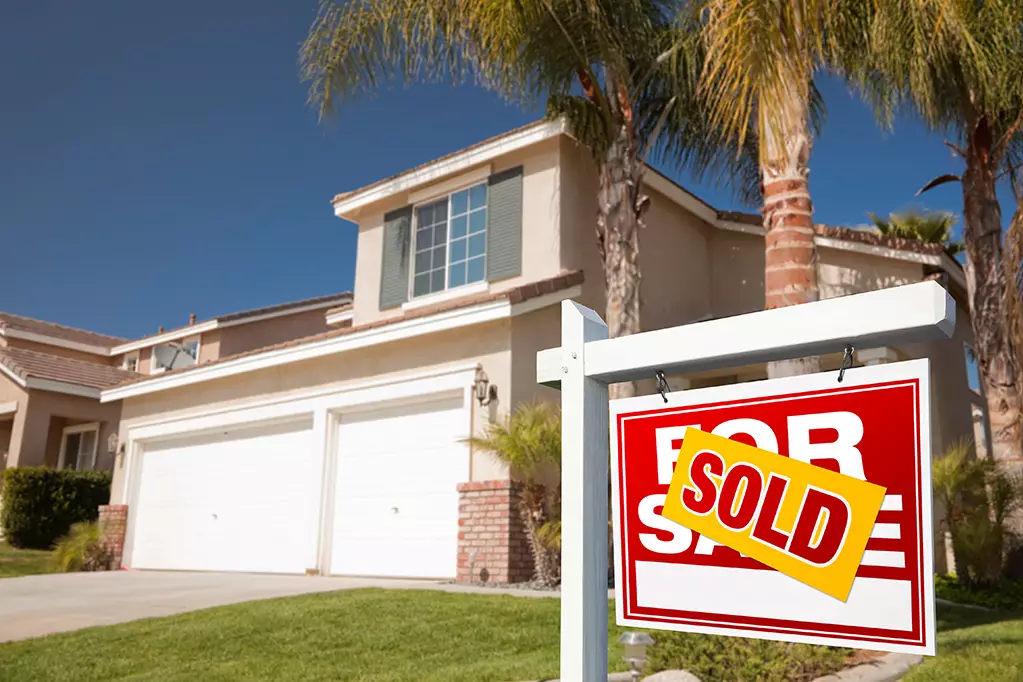 Red Sold For Sale Real Estate Sign in Front of House